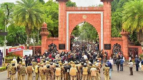 Police personnel stand guard outside Aligarh Muslim University as students protest against the passing of Citizenship Amendment Bill. (Photo | PTI)