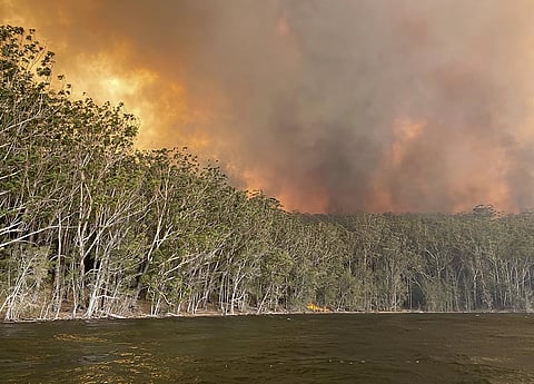 Smoke and wildfire rage behind Lake Conjola, Australia, Thursday, January 2, 2020. (Photo | AP)