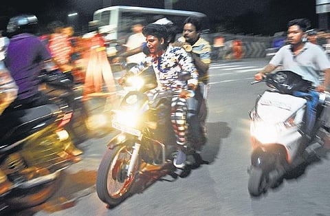 Bikers over speeding during new year celebrations at Marina on Tuesday night; bikes that were seized following road rules’ violations at Abiramapuram Police Station. (Photo | Ashwin Prasath, EPS)