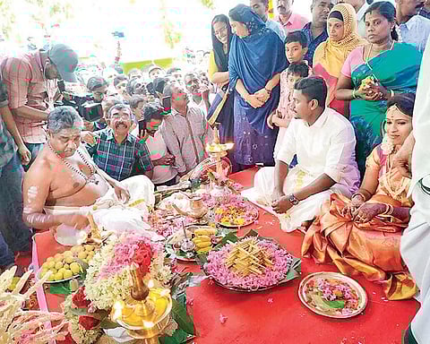 A priest conducts the wedding ceremony of Sarath Sasi and Anju Ashok on the Cheravally Muslim Jama’ath Mosque premises