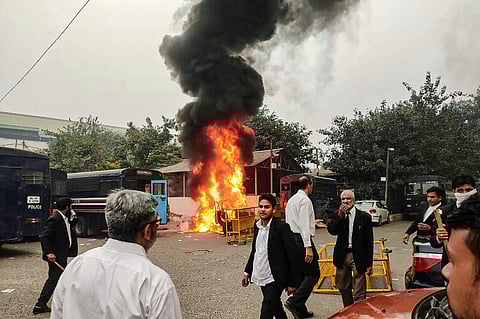 A view of a police vehicle being burnt down during clashes between lawyers and police personnel at Tis Hazari Court complex in New Delhi. (File Photo | PTI)