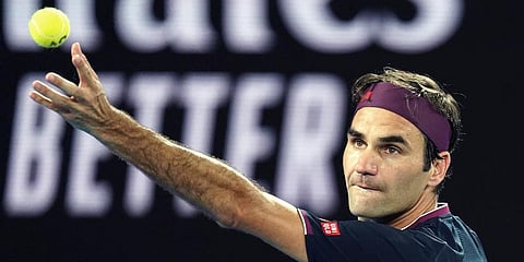 Switzerland's Roger Federer serves to United States' Steve Johnson during their first round singles match at the Australian Open tennis championship in Melbourne. (Photo | AP)