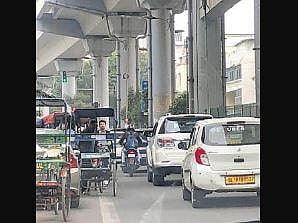 Halting e-rickshaws eat away the road width near the Metro station. (Photo | EPS)