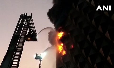 Fire and Emergency Service personnel trying to douse a blaze that broke out in Surat. ( Photo | ANI )