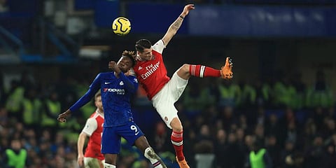 Chelsea's Tammy Abraham, left, challenges for the ball with Arsenal's Gabriel Martinelli during the English Premier League soccer match between Chelsea and Arsenal at Stamford Bridge stadium in London. (Photo | AP)