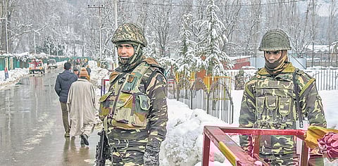 Security personnel stand guard  during a public outreach programme on the outskirts of Srinagar on Tuesday | PTI