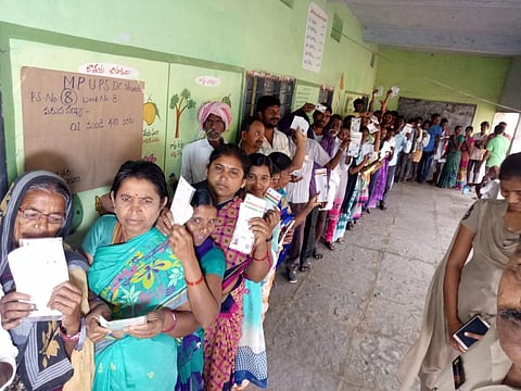 Voters are waiting in queue line to cast their vote at Wardhannapet Municipality. (Photo| EPS)