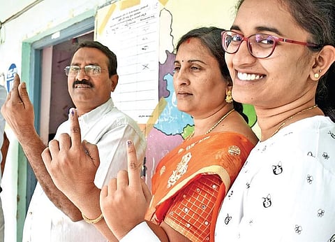 People are all smiles after casting their votes in Nizampet on Wednesday. (Photo | S Senbagapandiyan/EPS)