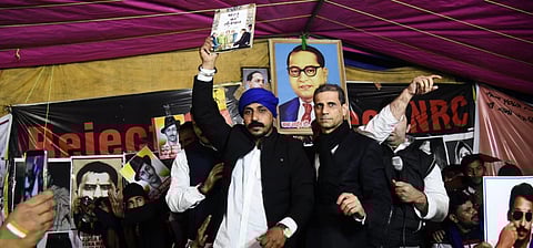 Bhim Army Chief Chandrasekhar Azad holds a copy of the Indian constitution during the ongoing protest against NRC and CAA at Shaheen Bagh in New Delhi. (Photo | Parveen Negi, EPS)