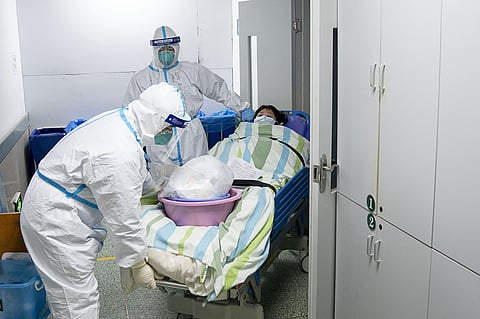 China expanded its lockdown against the deadly new virus to an unprecedented 36 million people and rushed to build a prefabricated, 1,000-bed hospital for victims. (Photo | AP)