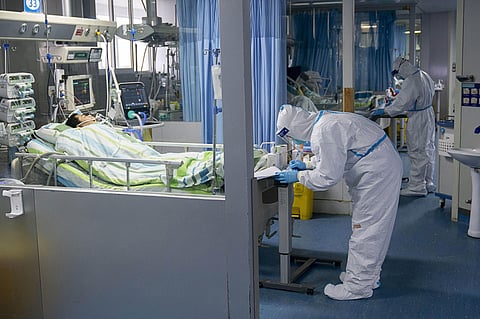 a medical worker attends to a patient in the intensive care unit at Zhongnan Hospital of Wuhan University in Wuhan in central China's Hubei Province. (Photo | AP)