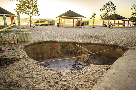 A sinkhole is surrounded by police tape after it appeared when a powerful magnitude 7.7 earthquake struck in the Caribbean Sea between Jamaica and eastern Cuba, at Public Beach on West Bay, Grand Cayman, Tuesday, Jan. 28, 2020. (Photo | AP)
