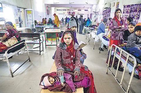 A mother waits for treatment of her child at the JK Lone Hospital in Kota district of Rajasthan on Thursday | PTI