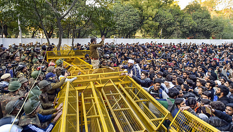 A police officer attempts to pacify students during their protest march against the Citizenship Amendment Act.. (Photo| PTI)