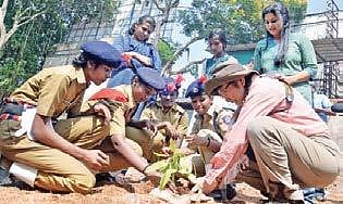 Student Police Cadets of Government High School, Chalai planting a sapling along with  Kazue Fujiwara, professor of Yokohama National University, as part of the micro forest project at the school. (Photo| Vincent Pulickal, EPS)