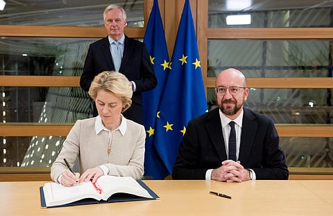 European Commission chief Ursula von der Leyen (L) and European Council president Charles Michel sign the agreement. (Photo| Twitter/ @vonderleyen)