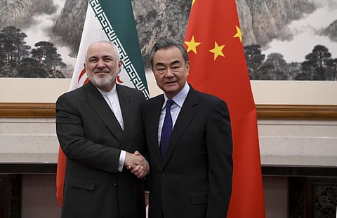 China's Foreign Minister Wang Yi (R) shakes hands with Iran's Foreign Minister Mohammad Javad Zarif (Photo| AP)