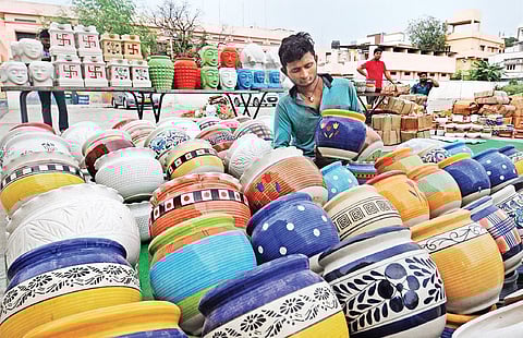 A vendor displays his wares at Shilparamam Gandhi Shilp Bazaar in  Vijayawada on Saturday. (Photo I EPS/Prasant Madugula)