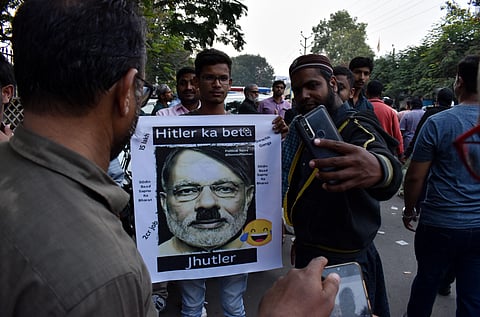 Protestors holding a placard of PM Modi depicting him as Hitler  (Photos | Vinay Madapu, S Senbagapandiyan, EPS)