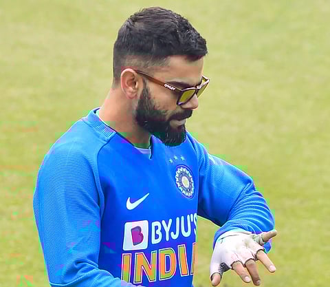 Indian skipper Virat Kohli looks at his injured finger during a training session ahead of the 1st T20 Match against Sri Lanka at Barsapara Cricket Stadium in Guwahati Saturday Jan. 4 2020. (Photo | PTI)