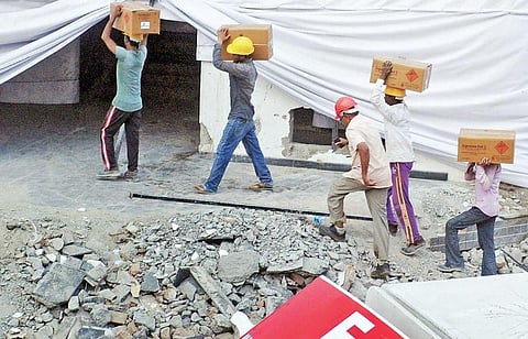 Employees of Edifice Engineering, the agency tasked with the controlled implosion of Holy Faith H2O, shifting the packages of ammonium nitrate from the explosive van to the structure on Saturday | A Sanesh