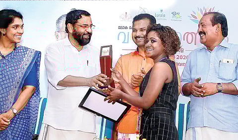 TNIE reporter Aathira Haridas receives the award from Minister Kadakampally Surendran in Thiruvananthapuram (Photo | B P Deepu, EPS)