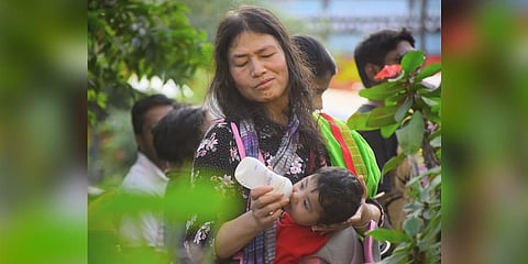 Activist Irom Sharmila feeds one of her twin daughters during a protest against the Citizenship Amendment Act, National Register of Citizens, and National Population Register, in Bengaluru on Sunday. (Photo | Pandarinath B, EPS)
