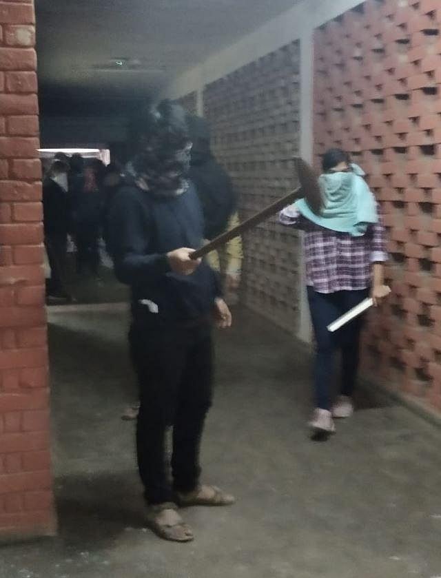 Masked micreants seen holding wooden and metal rods. Destruction wreaked in the JNU campus on Sunday evening. (Photo | Twitter)