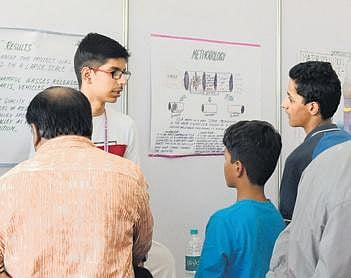 Numair Muzzaffar speaks to other children at his stall, at the Indian Science Congress (Photo | Meghana Sastry, EPS)