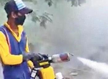 A BeMC worker using a hand held fogging machine  | Express