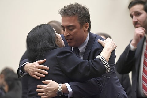 In this March 7, 2019, file photo, Christine Levinson, wife of Robert Levinson, a former FBI agent who vanished in Iran in 2007, left, gets a hug from Babak Namazi, right, the son of Baquer Namazi who has been held in Iran, following their testimony befor