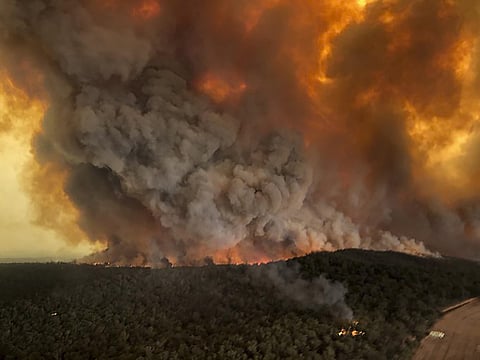 In this Monday, Dec. 30, 2019, aerial file photo, wildfires rage under plumes of smoke in Bairnsdale, Australia. (File Photo | AP)