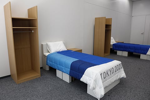 Two sets of bedroom furniture, including cardboard beds, for the Tokyo 2020 Olympic and Paralympic Villages are shown in a display room. (Photo | AP)