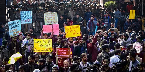 JNU students gather at the entrance gate of the Jawaharlal Nehru University before leaving for their protest march from Mandi House to HRD Ministry, demanding removal of the university vice-chancellor, in New Delhi. (Photo | PTI)