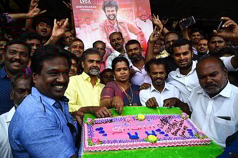 Rajinikanth fans celebrating the release of  'Darbar' movie by cutting a cake in front of theater in Coimbatore on Thursday. (Photo | A Raja Chidambaram, EPS)
