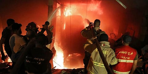 Firefighters extinguish a fire at a building after a diesel tank exploded in the neighborhood of Tarik al-Jadida in Beirut. (Photo | AP)