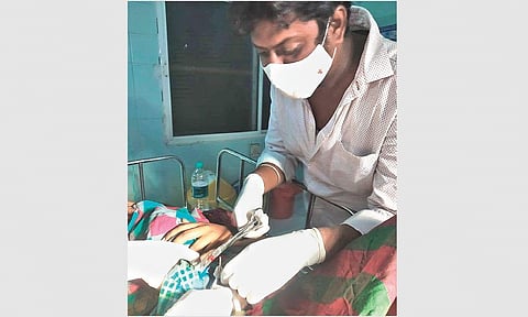 Satyanarayana cuts the umbilical cord of his baby girl  at the Mahabubabad District Hospital on Thursday