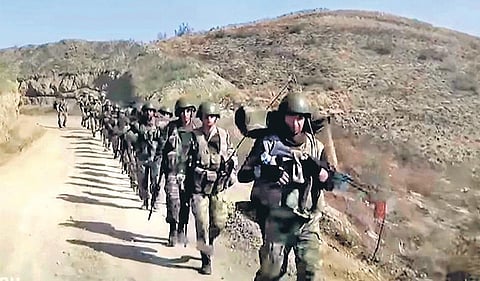 Azerbaijan’s solders walk in a formation on a road during a military conflict in the separatist region of Nagorno- Karabakh | AP