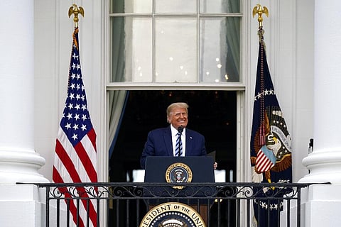 President Donald Trump speaks from the Blue Room Balcony of the White House to a crowd of supporters on Saturday. (Photo | AP)