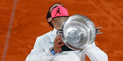 Rafael Nadal holds the trophy as he celebrates winning the final match of the French Open tennis tournament against Novak Djokovic. (Photo | AP)