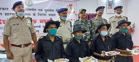 Maoist zonal commander Boyda Pahan (in white mask) and his three aides with cops after surrender (Photo | EPS)