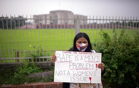 A women’s rights activist among those protesting against gender based violence holds a placard outside the Parliament in Dhaka, Bangladesh. (Photo | AP)