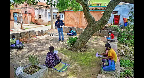 A file photo of a teacher holding Vidyagama classes in Nelamangala, with Covid-19 norms in place. (Photo | Shriram BN , EPS)