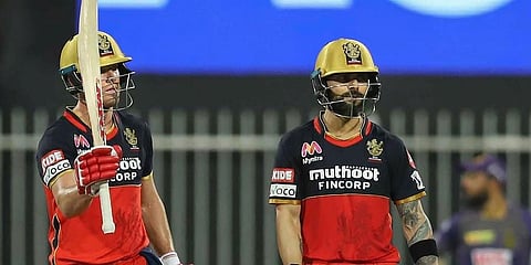 RCB's AB de Villiers raises his bat after scoring a half century with Virat Kohli nearby during IPL match against Kolkata Knight Riders. (Photo | PTI)