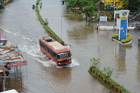 A bus moves through waterlogged Karad-Vita highway following heavy rain, in Maharashtra. (Photo | PTI)