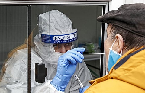 Medical staff takes a COVID-19 test at a coronavirus test center in Cologne, Germany (Photo | AP)