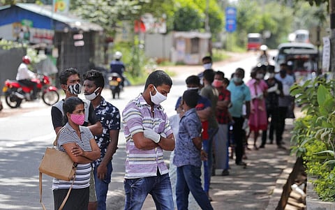 Sri Lankans wait to give swab samples to test for COVID-19 outside a hospital in Minuwangoda (Photo | AP)