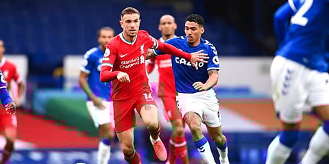 Liverpool's Jordan Henderson competes for the ball with Everton's Allan during the Merseyside derby at Goodison Park. (Photo | AP)
