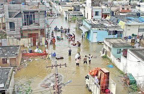 Residents of Uma Maheshwara Colony pick up their belongings from their flood-hit homes.