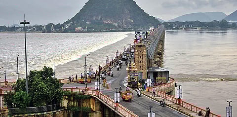 The flood water being released downstream Prakasam Barrage in Vijayawada on Friday. (Photo I EPS/Prasant Madugula)